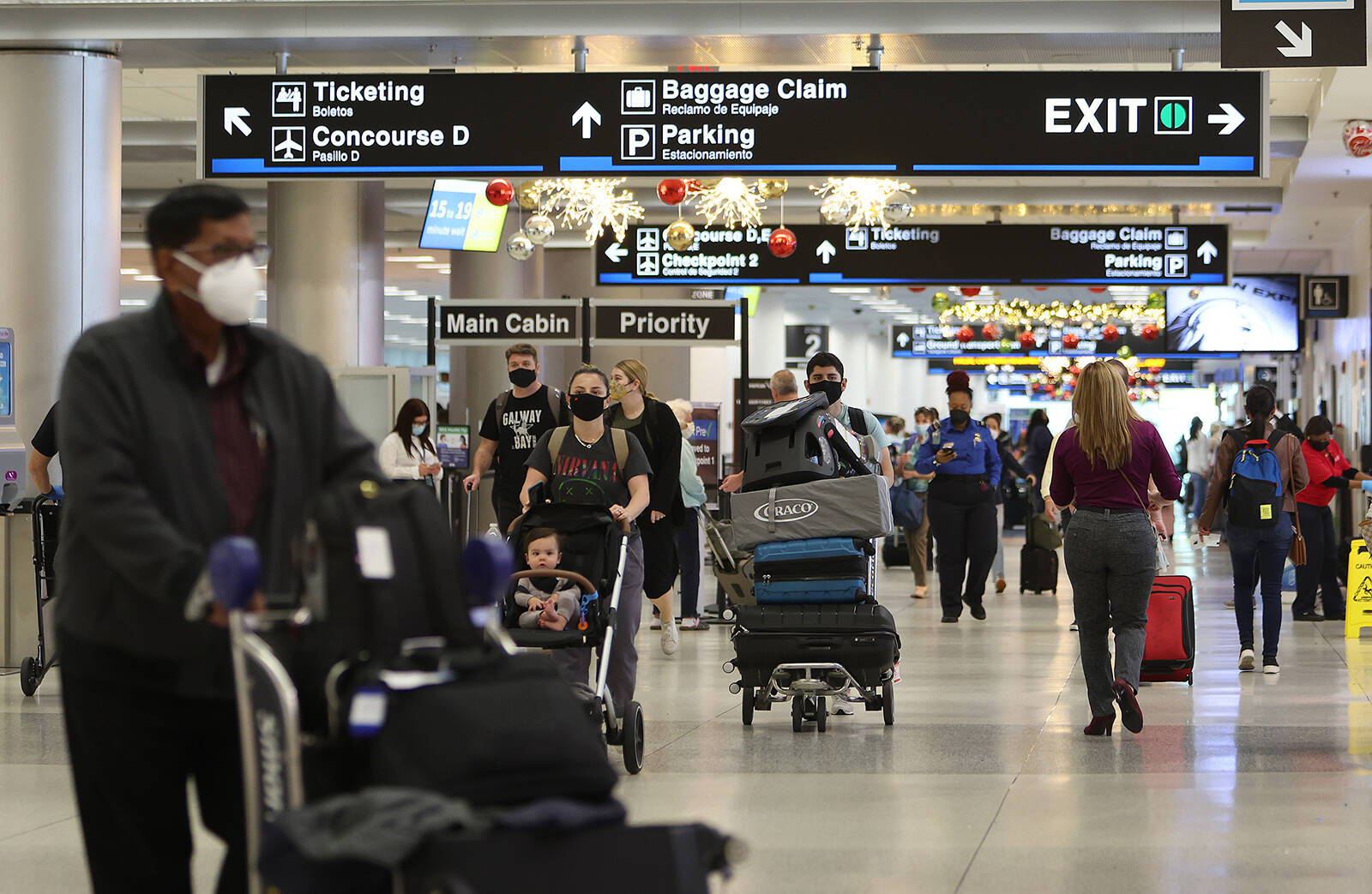 Joe Raedle | Getty Images | TNS
Travelers make their way through Miami International Airport on Tuesday, Dec. 28, 2021.