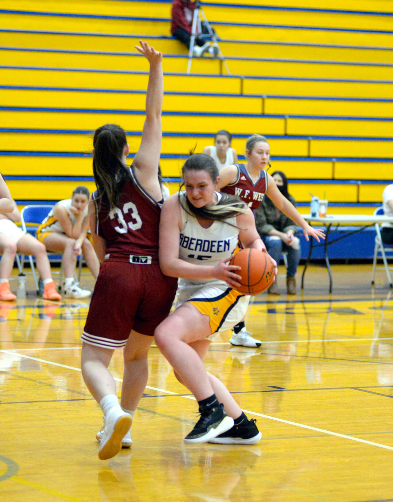 RYAN SPARKS | THE DAILY WORLD Aberdeen center Zoe Filan, right, maneuvers around WF West forward Maggie Bussee during Aberdeen’s 66-28 loss to WF West on Tuesday in Aberdeen.