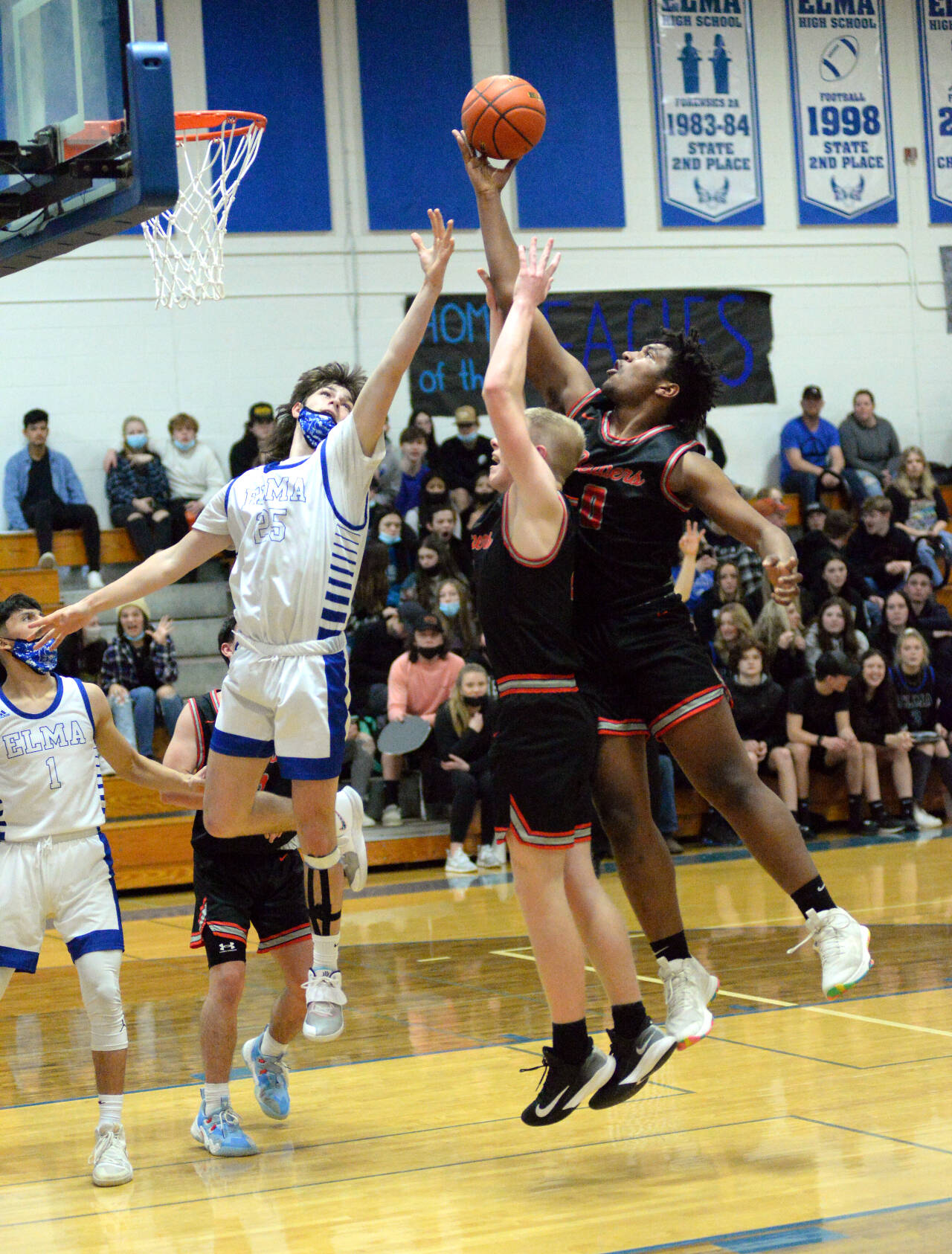 RYAN SPARKS | THE DAILY WORLD Elma’s Gibson Cain (25) and Tenino’s Takari Hickle (0) leap for a rebound during Elma’s 50-47 loss on Tuesday in Elma.