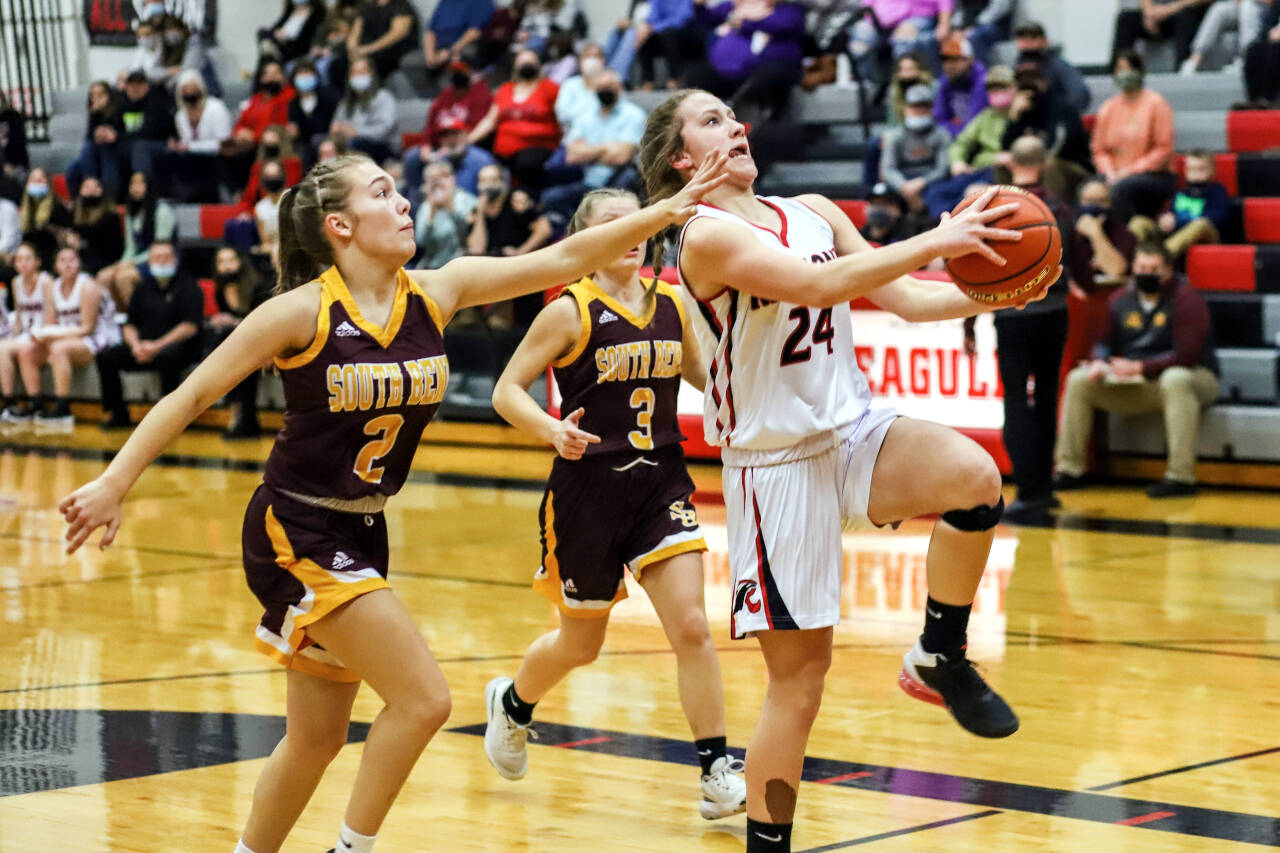 PHOTO BY LARRY BALE Raymond freshman Karsyn Freeman (24) drives for a layup against South Bend’s Elli Capps (2) during Raymond’s 66-4 victory on Thursday at Raymond High School.