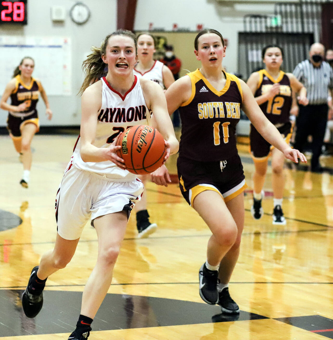 PHOTO BY LARRY BALE Raymond’s Kyra Gardner, left, drives to the basket against South Bend’s Reece Williams during the Seagulls 66-4 victory on Thursday in Raymond.