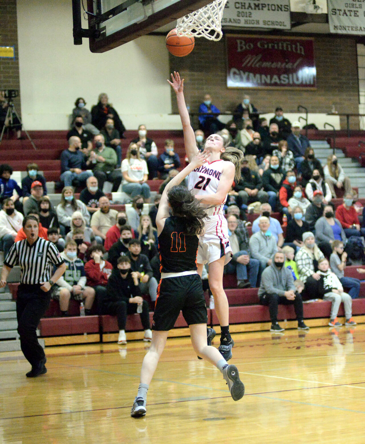 RYAN SPARKS | THE DAILY WORLD Raymond senior guard Kyra Gardner (21) scores two of her game high 22 points in a 49-32 victory over Rainier in a 2B District 4 quarterfinal game on Tuesday in Montesano.