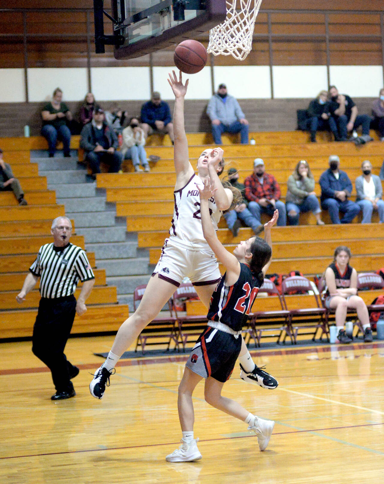 RYAN SPARKS | THE DAILY WORLD Montesano senior Paige Lisherness (23) glides to the basket against Columbia-White Salmon’s Chloe Clifford to score two of her game high 32 points in the Bulldogs’ 79-29 victory on Friday in Montesano.