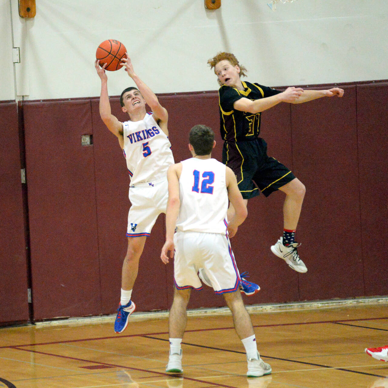 RYAN SPARKS | THE DAILY WORLD Willapa Valley forward Wil Clements (5) leaps for a rebound against Sunnyside Christian’s Buddy Smeenk during the Vikings’ 65-59 victory in a 1B Regional round game on Saturday at WF West High School in Chehalis.