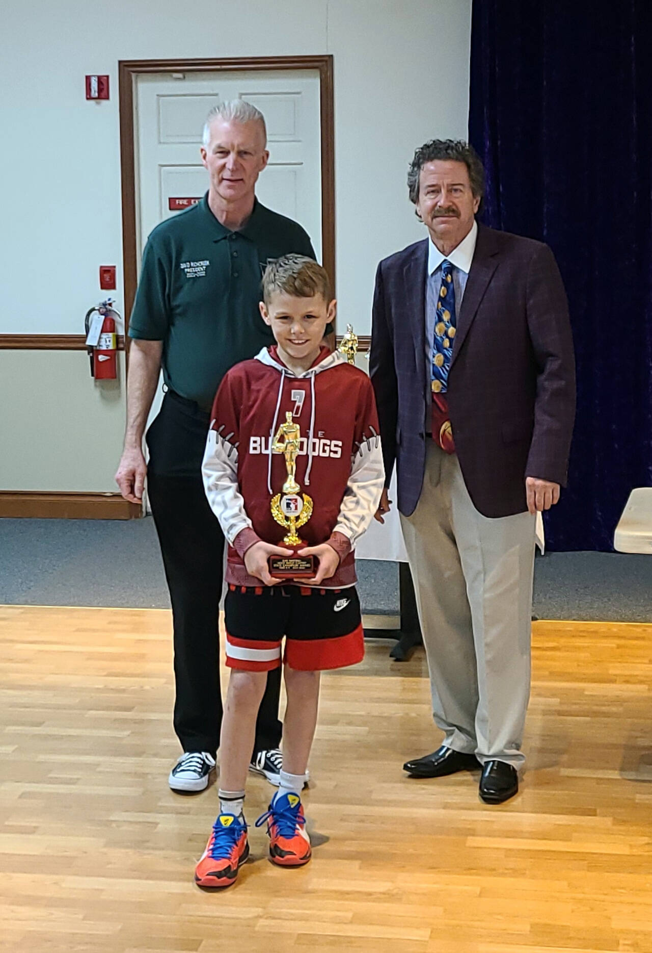SUBMITTED PHOTO Lawyer Niemi of Montesano won the state championship of the Elks Hoop Shoot Saturday at St. Martin’s University in Lacey after sinking 21-of-25 shots in the boys 8-9 year-old competition. Niemi is flanked by WA Elks Association President Dave Richcreek, left, and Washington Hoop Shoot Director Joe Basil.