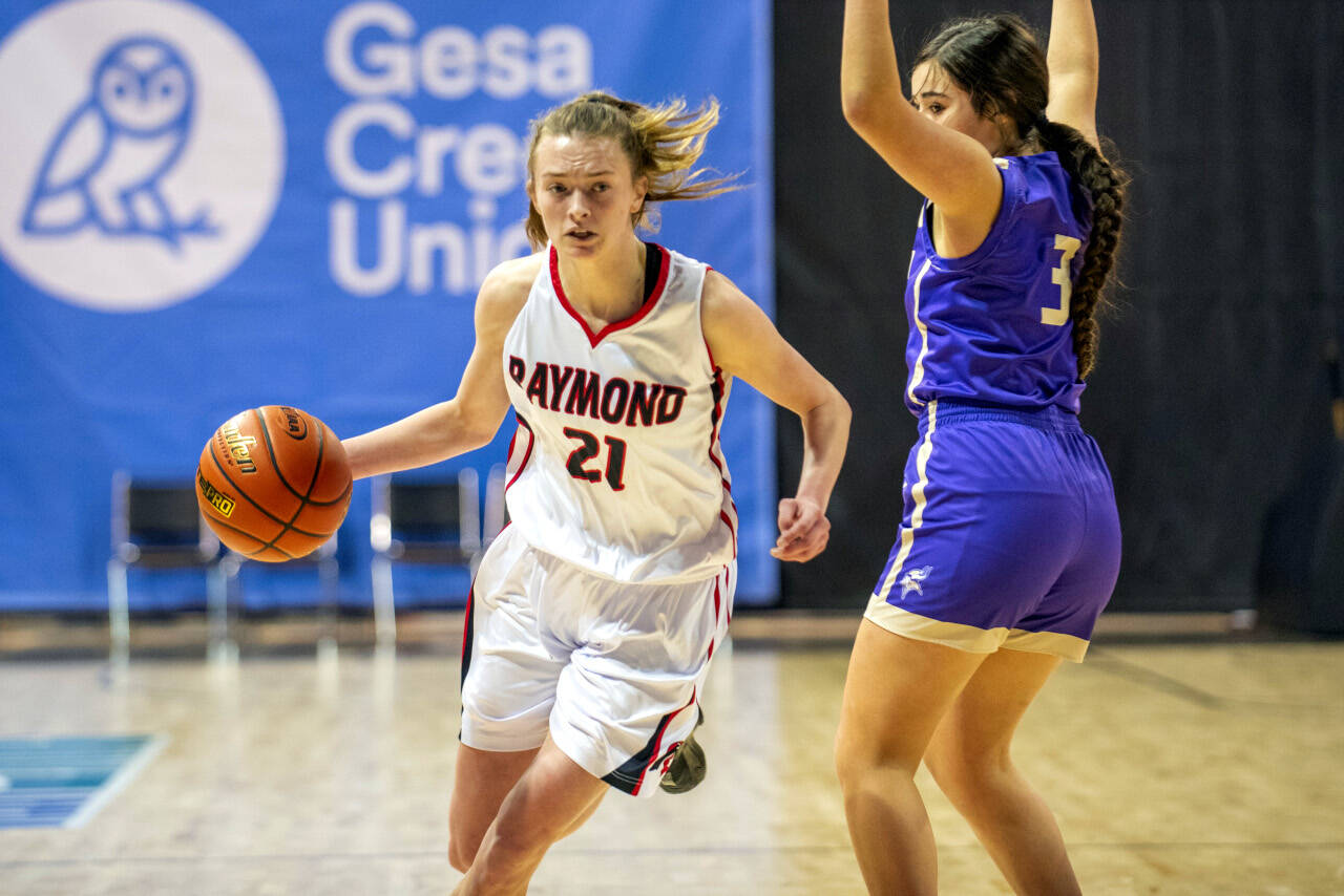 ERIC TRENT | THE CHRONICLE Raymond guard Kyra Gardner (21) dribbles past Mabton power forward Jasmin Chavez during the Seagulls’ 65-44 victory in the first round of the 2B State Tournament on Wednesday, March 2, 2022 at the Spokane Arena. Gardner led all scorers with 30 points.