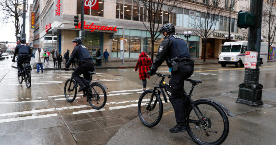 Jennifer Buchanan | The Seattle TImes | TNS 
Three Seattle bicycle officers cross 3rd Avenue at Pike Street on Monday, March 14, 2022, in downtown Seattle.
