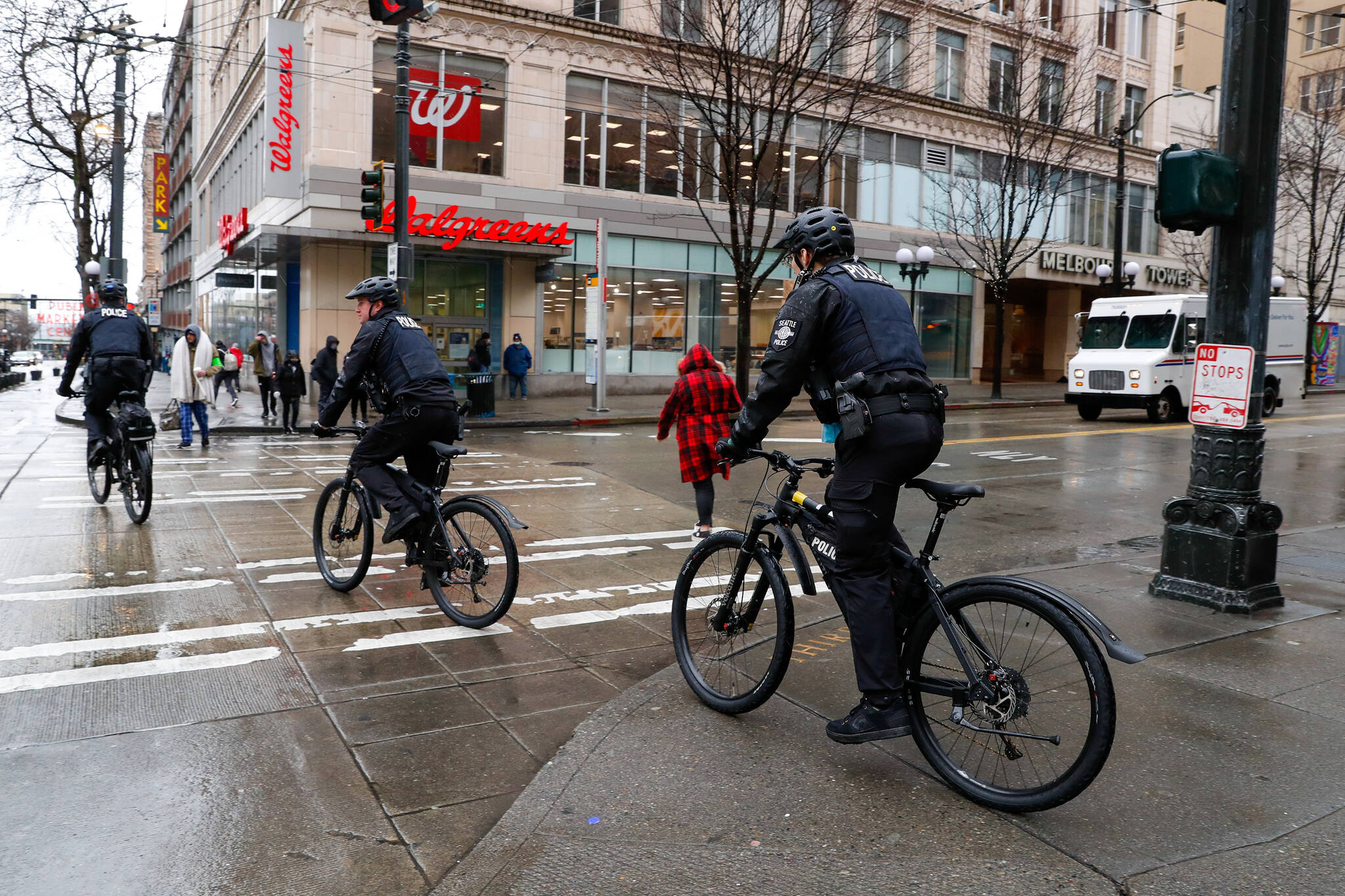 Jennifer Buchanan | The Seattle TImes | TNS 
Three Seattle bicycle officers cross 3rd Avenue at Pike Street on Monday, March 14, 2022, in downtown Seattle.