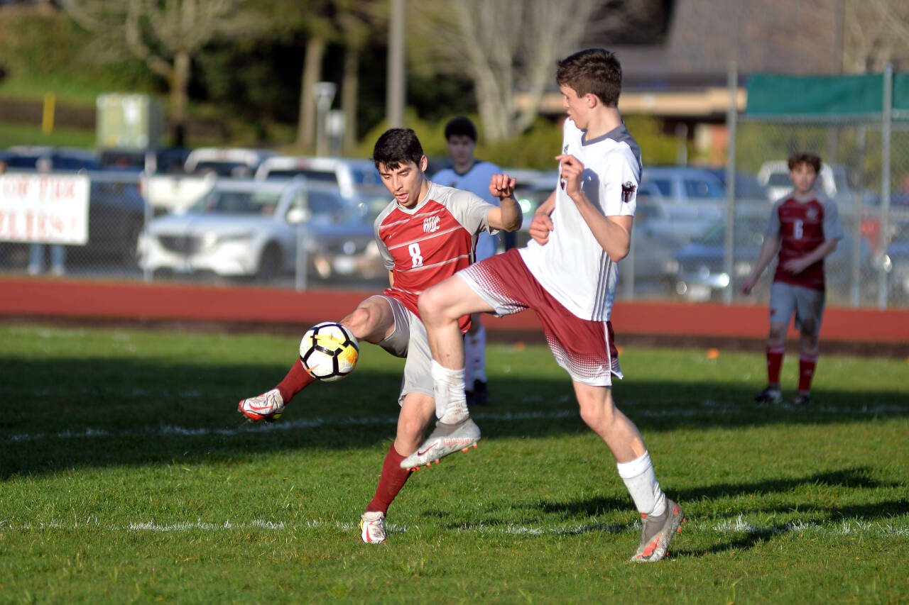 RYAN SPARKS | THE DAILY WORLD Hoquiam midfielder Alan Ramirez (8) sends the ball forward while being defended by Montesano’s Levi Clements during the Bulldogs’ 3-1 win on Tuesday at Sea Breeze Oval in Hoquiam.