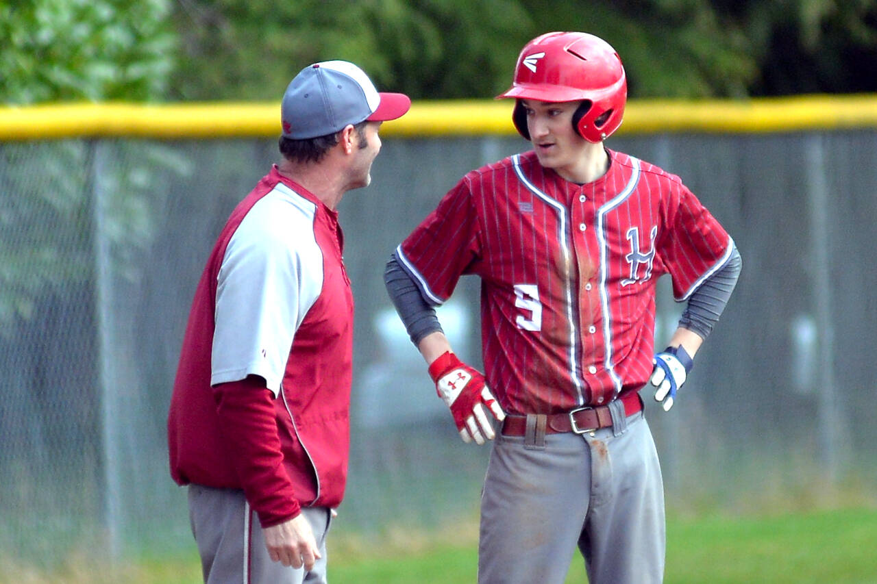 RYAN SPARKS | THE DAILY WORLD Hoquiam head coach Steve Jump talks with Grizzlies outfielder Chase Schumate after Schumate drove in a run with a double in a loss to Montesano on Monday at Vessey Field in Montesano.
