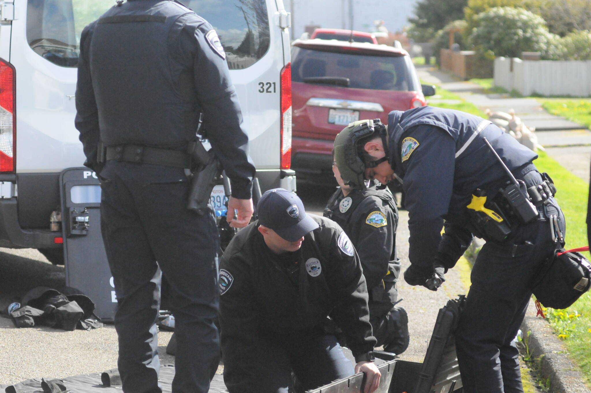 Hoquiam Police Officers start to unload equipment after 19-hour police standoff with juvenile at a residence in the 2700 block of Queets Avenue, which ends peacefully with him surrendering himself to law enforcement. Matthew N. Wells | The Daily World