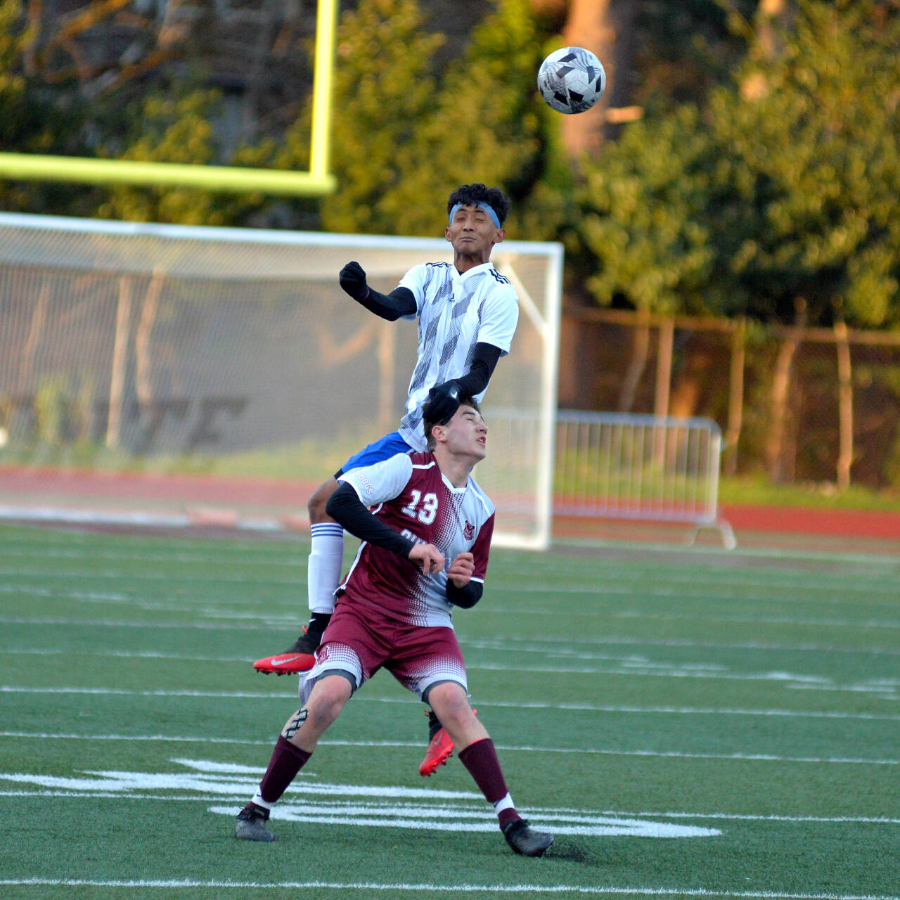RYAN SPARKS | THE DAILY WORLD Elma defender Ivan Garcia leaps over Montesano’s Felix Romero (13) for a header during Elma’s 3-1 win on Wednesday in Montesano.