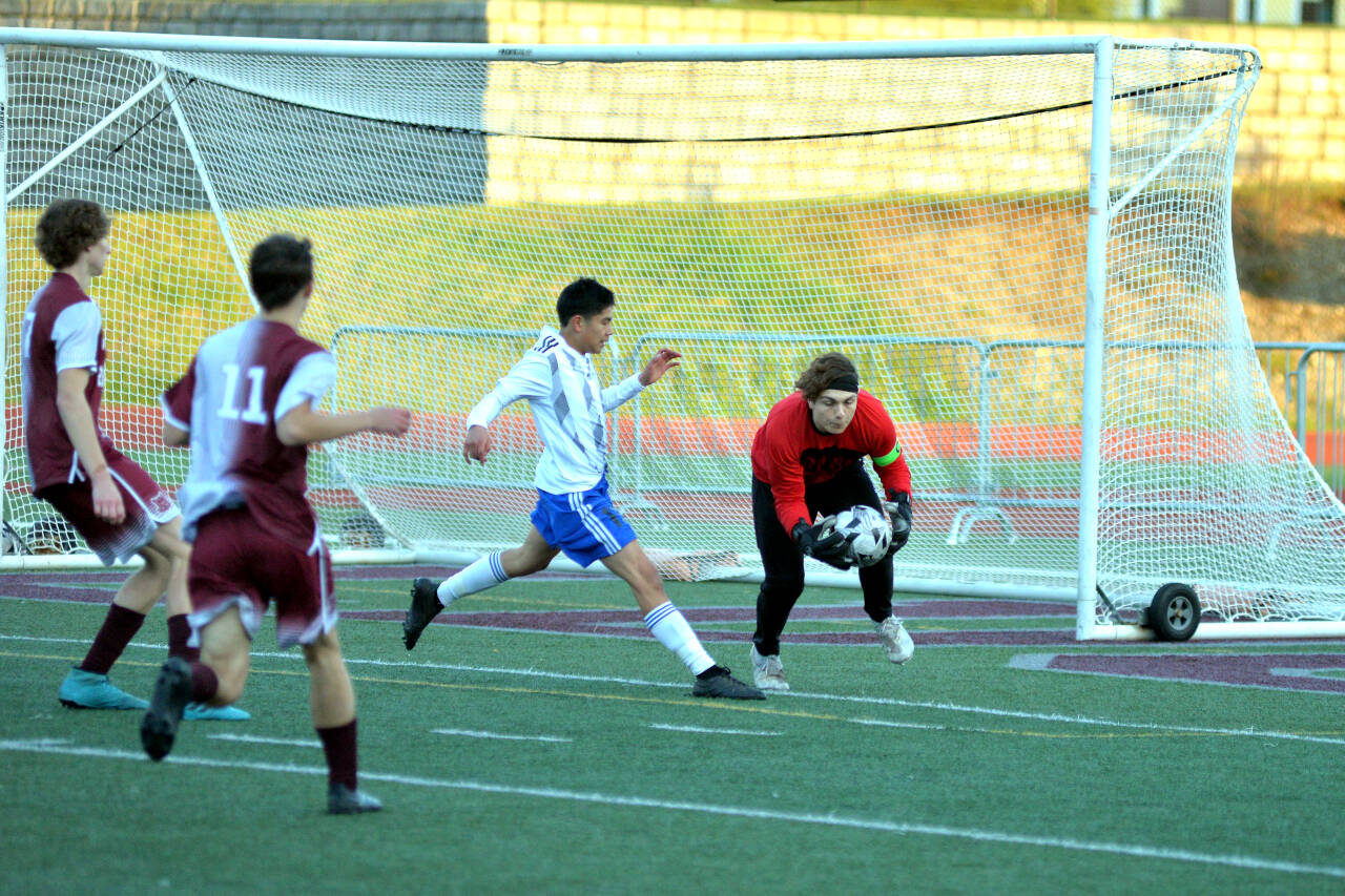 RYAN SPARKS | THE DAILY WORLD Montesano goal keeper Jayden McElravy, right, collects the ball ahead of onrushing Elma attacker Valencia Mendoza during Elma’s 3-1 win on Wednesday at Montesano High School.
