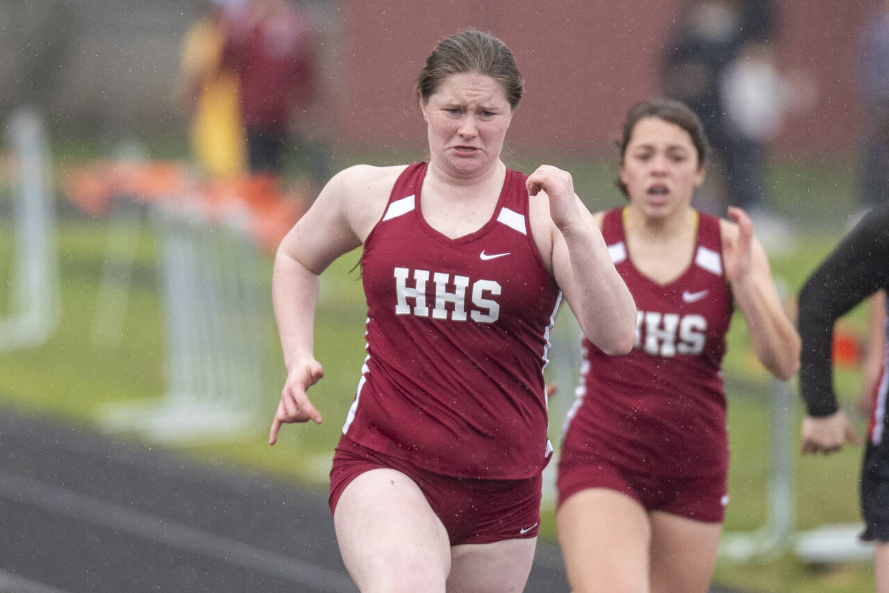 ERIC TRENT | THE CHRONICLE Hoquiam’s Katie Burnett, left, ran a season-best time of 13.94 to place second in the 100 meter spring on Thursday at Tiger Stadium in Napavine.