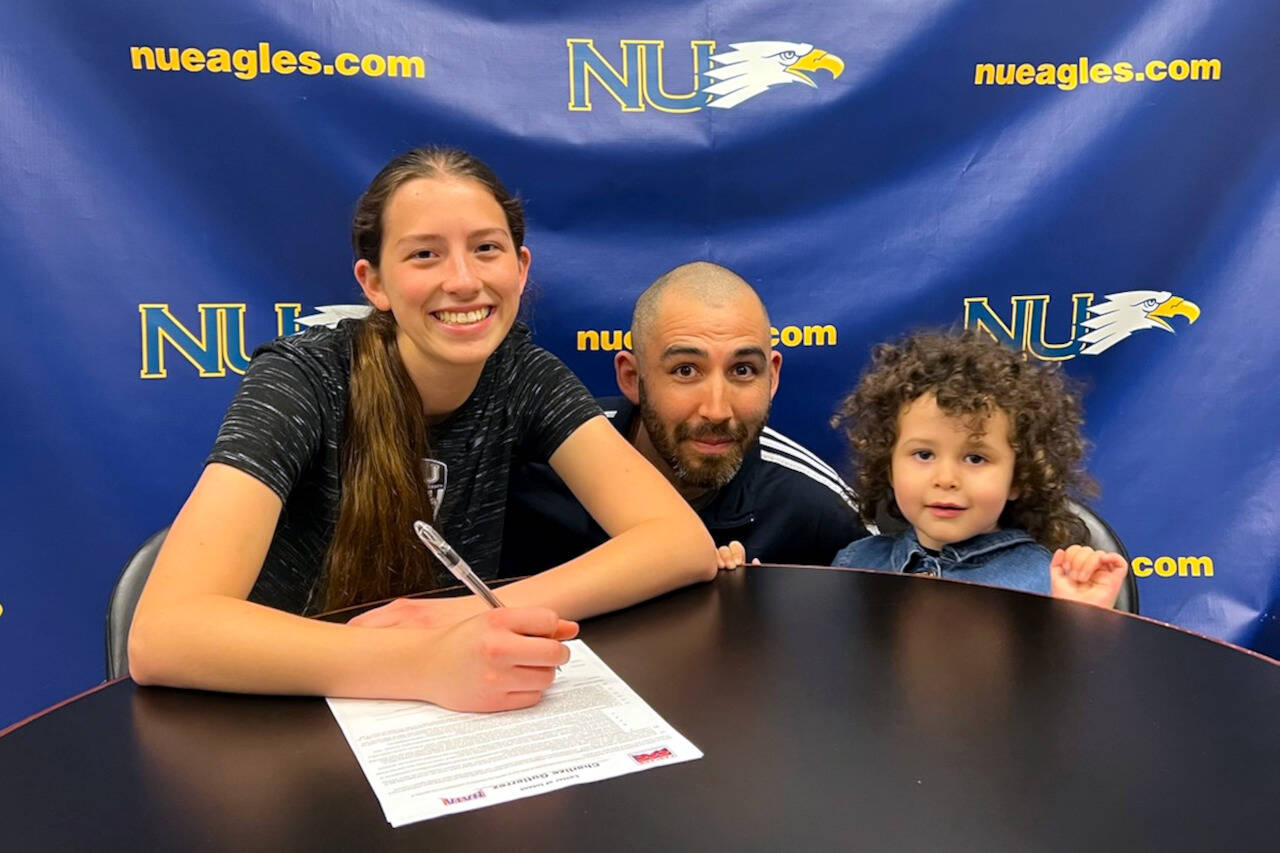 SUBMITTED PHOTO Aberdeen High School goal keeper Char Gutierrez, left, signed a National Letter of Intent on March 31 to attend Northwest University in Kirkland in the fall. Gutierrez is pictured with her father, Anthony, and sister, Maze.