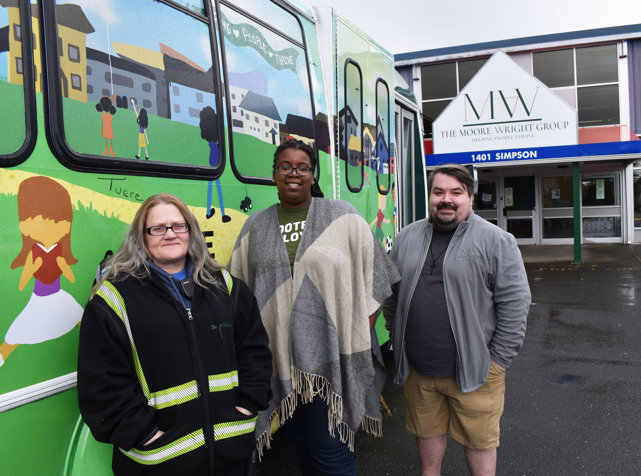 The Moore Wright Group’s Executive Director Tanikka Watford, center, stands with Sarah Eliassen, who worked from a difficult past to the nonprofit organization’s housing coordinator, and Brady Figueredo, right, TMWG’s executive coordinator. (Matthew N. Wells | The Daily World)