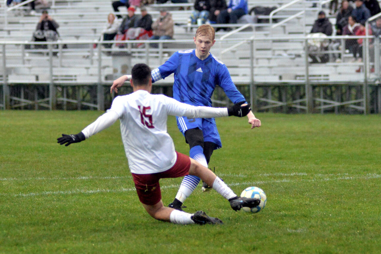 RYAN SPARKS | THE DAILY WORLD Elma senior forward Canon Seaberg takes a shot while being defended by Hoquiam senior Roman Bedolla during Elma’s 9-0 win on Wednesday at Davis Field in Elma.