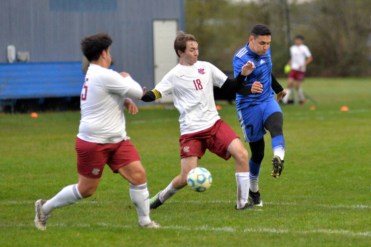 RYAN SPARKS | THE DAILY WORLD Elma midfielder Valencia Mendoza, right, scores on a shot while being defended by Hoquiam senior Kolby Skolrood during Elma’s 9-0 win on Wednesday at Davis Field in Elma.