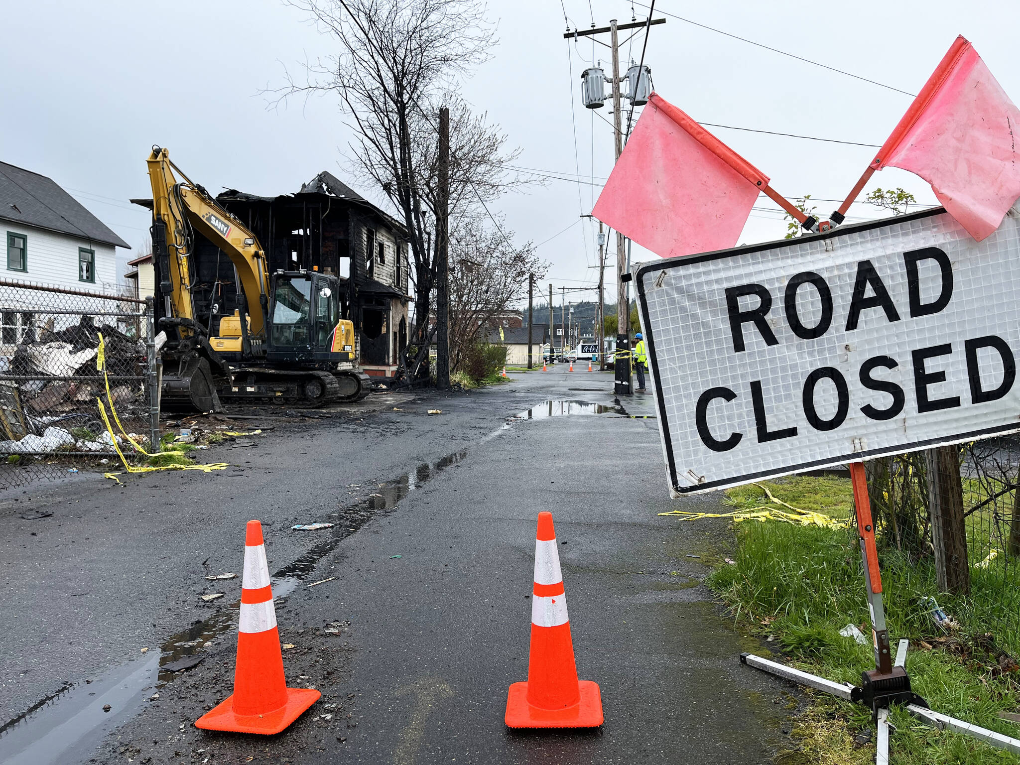 On Tuesday, April 26, an excavator sits outside the main part of the still-standing two-story residence at 215 N. H St., in Aberdeen, which went up in flames early Saturday morning, April 23. (Matthew N. Wells | The Daily World)
