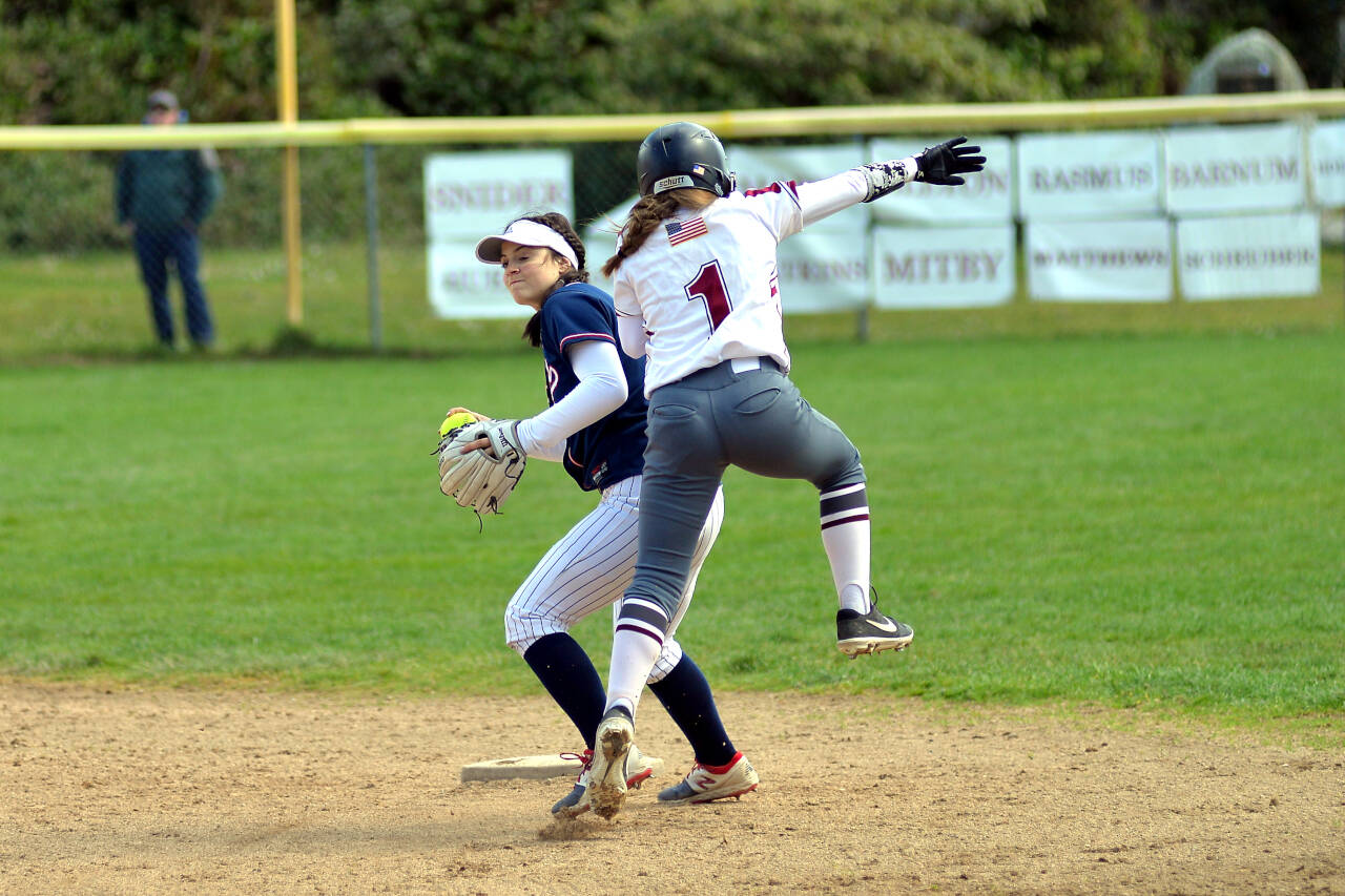 RYAN SPARKS | THE DAILY WORLD Ocosta runner Brynn Rasmus (1) is called for interference on Pe Ell-Willapa Valley shortstop Raegan Portmann during a doubleheader on Tuesday in Westport.
