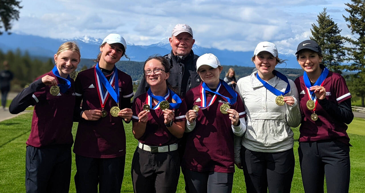 SUBMITTED PHOTO The Montesano Bulldogs (from left) Jessie LaLonde, Maggi Kupka, Hailey Blancas, head coach Doug Galloway, Iza Cope and Audree Dohrmann (far left) teamed up with Elma golfer Camberly Burgess (second from right) to win the team title at the Sibley Scramble Tournament at Alderbrook Golf Course in Union on Monday. Blancas and Kupka tied for first with a score of 77.