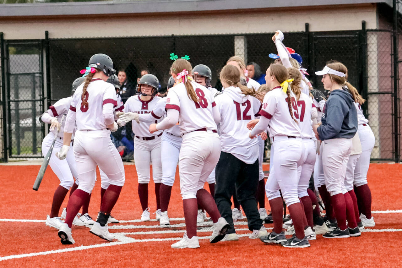 PHOTO BY SHAWN DONNELLY Montesano senior Paige Lisherness (8) celebrates with her teammates after hitting a grand slam home run in the seventh inning in a 10-5 win over Eatonville on Friday in Montesano.
