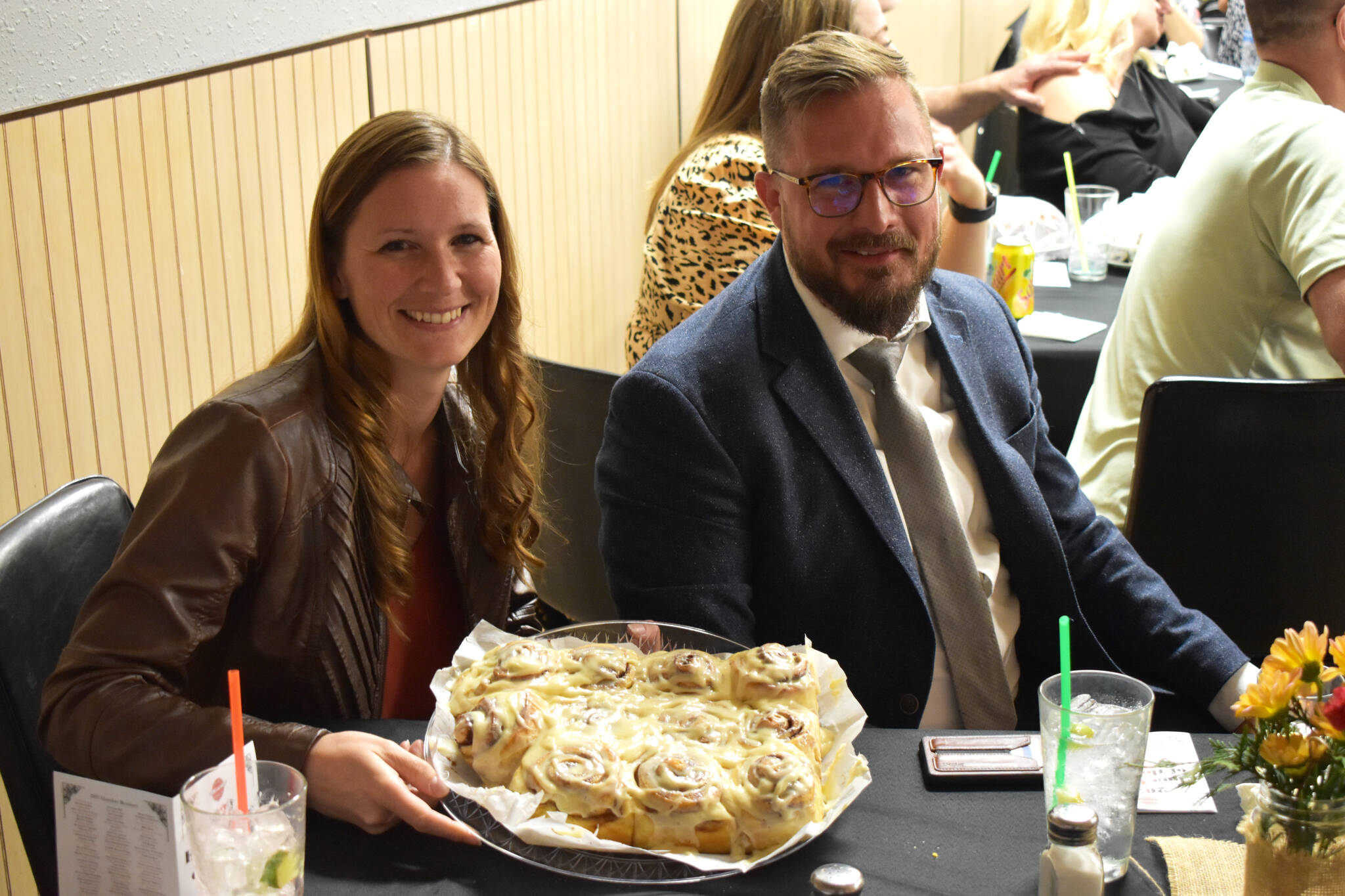 Kassey Robbins (left) holds a plate of cinnamon rolls she won for $200 in a dessert auction for the 2022 Elma Citizen of the Year event at the Elma Eagles Banquet Hall on April 29, 2022.