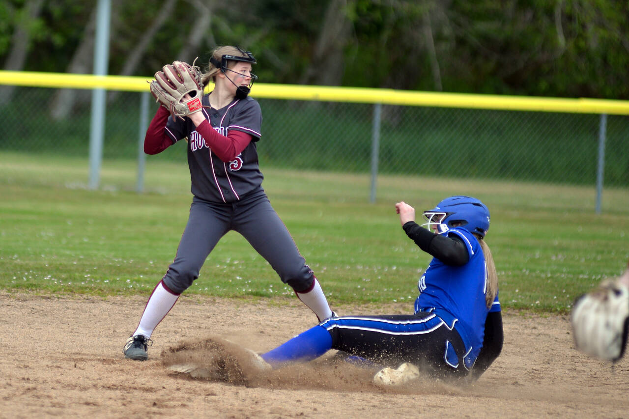 RYAN SPARKS | THE DAILY WORLD Houqiam second baseman Ella Folkers (5) looks to turn a double play as Eatonville’s Dakota Smith slides in to second base during a doubleheader on Tuesday in Hoquiam.
