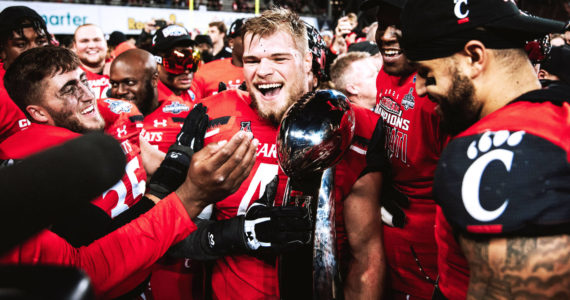 Photo courtesy of Joel Dublanko 
Joel Dublanko (center) celebrates with teammates following the Bearcats AAC Championship game victory over the Houston Cougars on Dec. 4, 2021, at Nippert Stadium in Cincinnati, Ohio.
