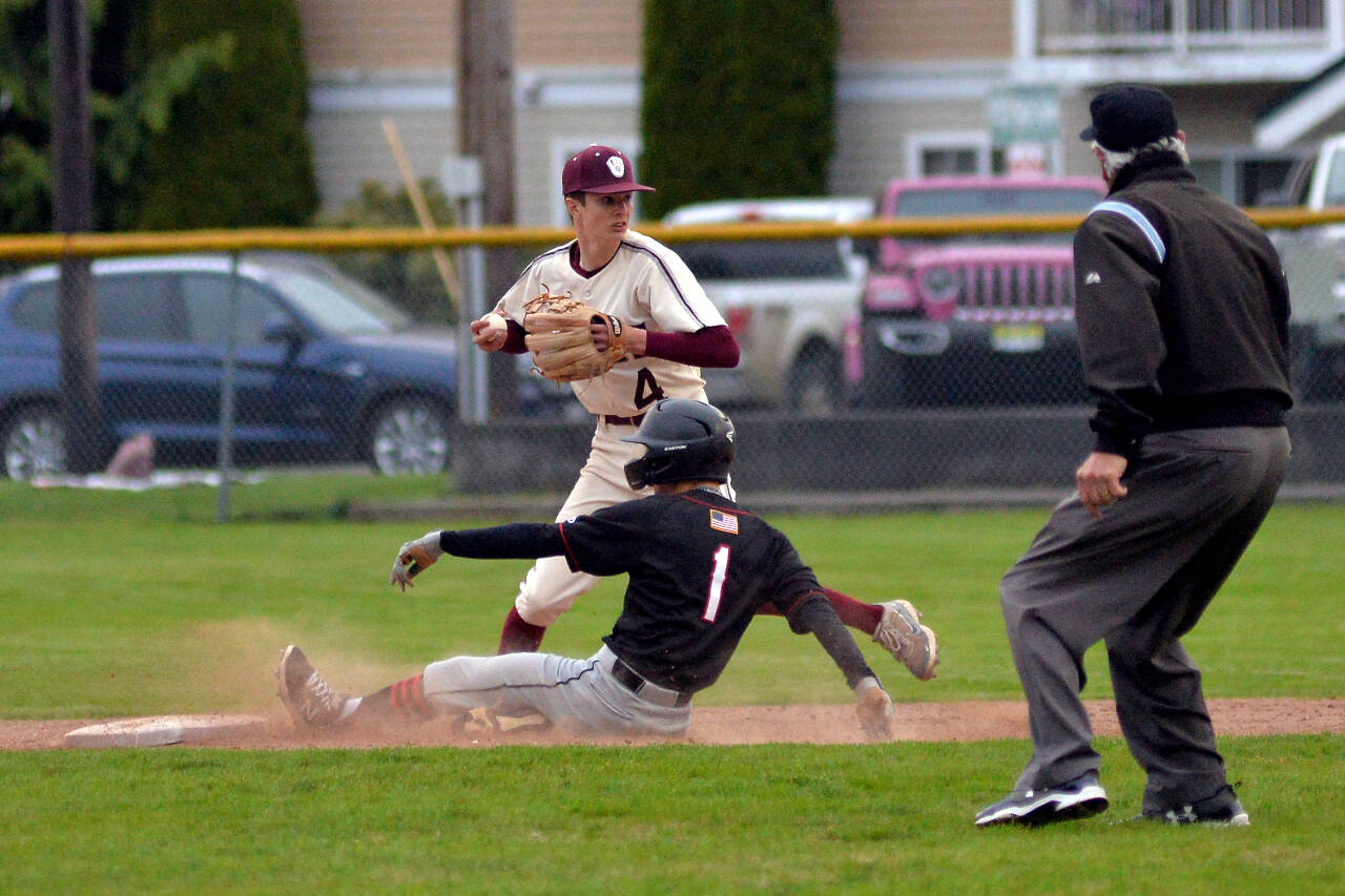 RYAN SPARKS | THE DAILY WORLD Montesano infielder Bode Poler (4) looks to turn a double play as Tenino’s Kaden Sayamnet slides in during Monte’s 11-4 victory over Tenino on Wednesday in Montesano.