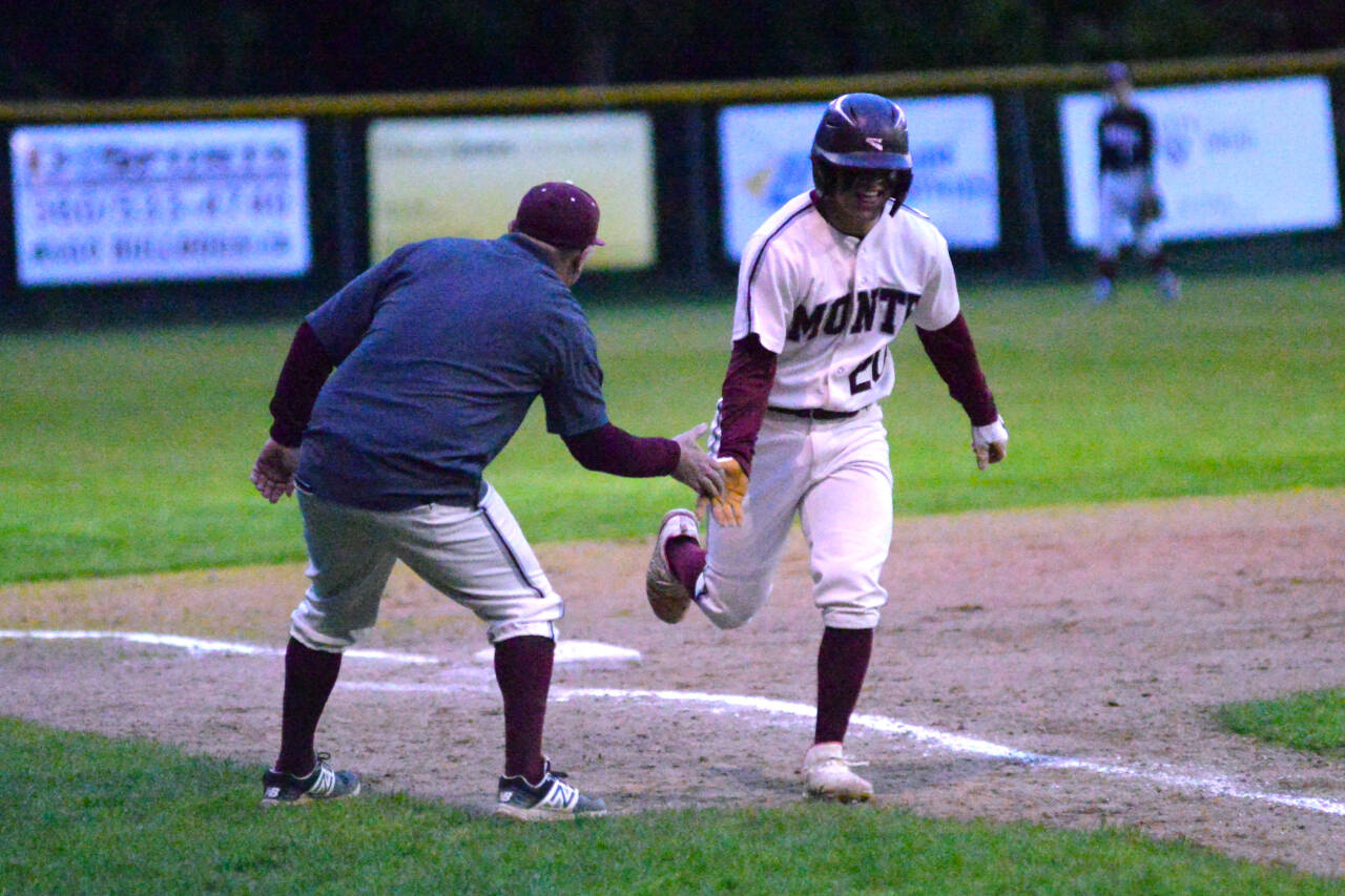 RYAN SPARKS | THE DAILY WORLD 
Montesano third baseman Isaac Pierce gets a low-five from head coach Mike Osgood after belting a solo home run in the fifth inning of the Bulldogs’ 11-4 victory over Tenino on Wednesday, May 4, 2022, at Vessey Field in Montesano.