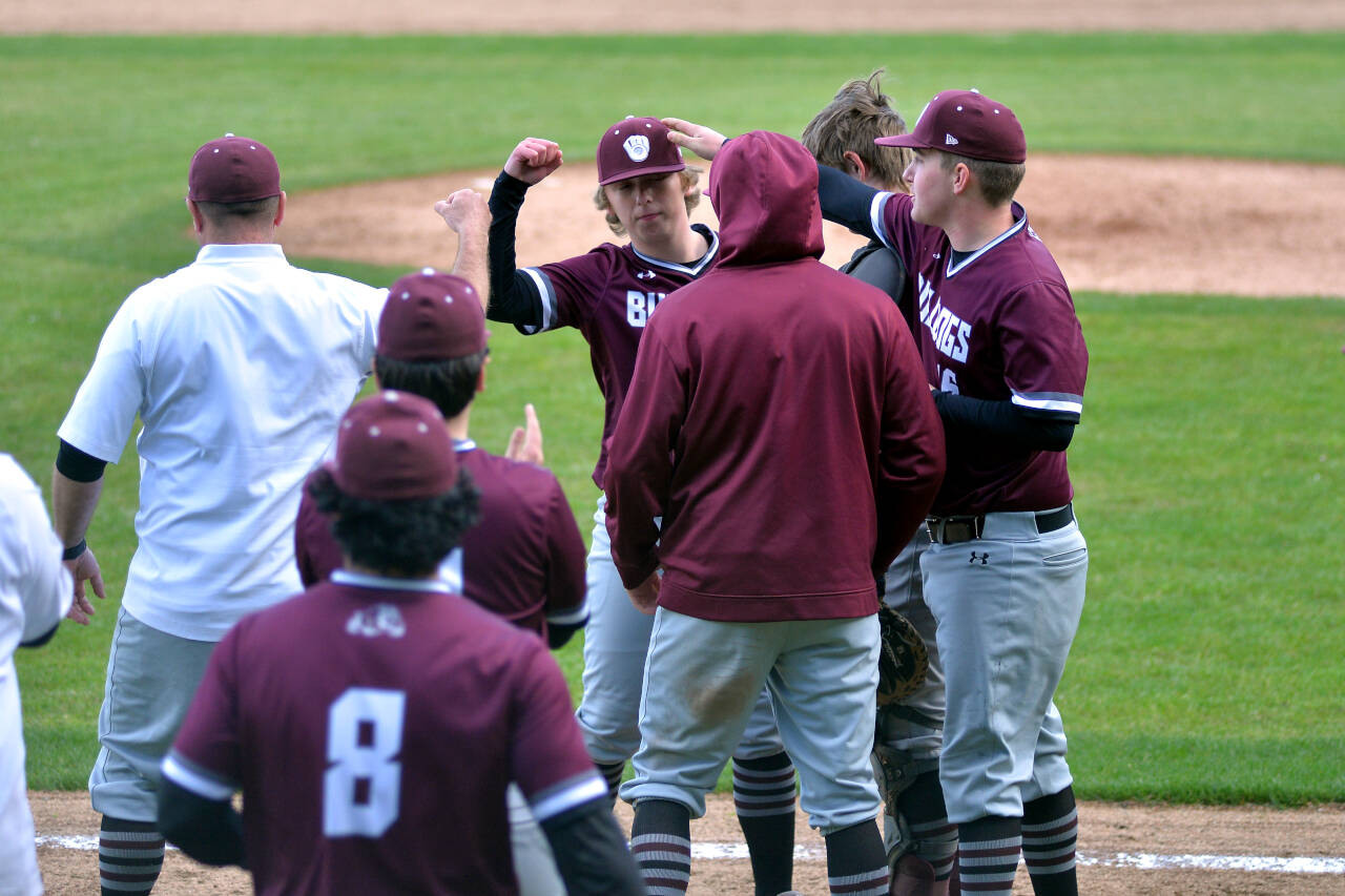 RYAN SPARKS | THE DAILY WORLD Montesano relief pitcher Skylar Bove, second from left, is congratulated after getting the final out of a 13-2 victory over Columbia-White Salmon in the first round of the 1A District 4 playoffs on Monday at Olympic Stadium in Hoquiam.