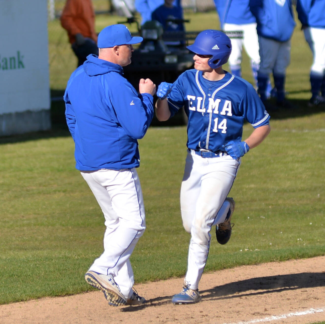 RYAN SPARKS | THE DAILY WORLD Elma’s Jerred Bailey (14) gets a fist bump from head coach Travis Vessey after belting a two-run home run in the seventh inning of the Eagles’ 10-3 1A District 4 semifinal win over Tenino on Tuesday in Hoquiam.