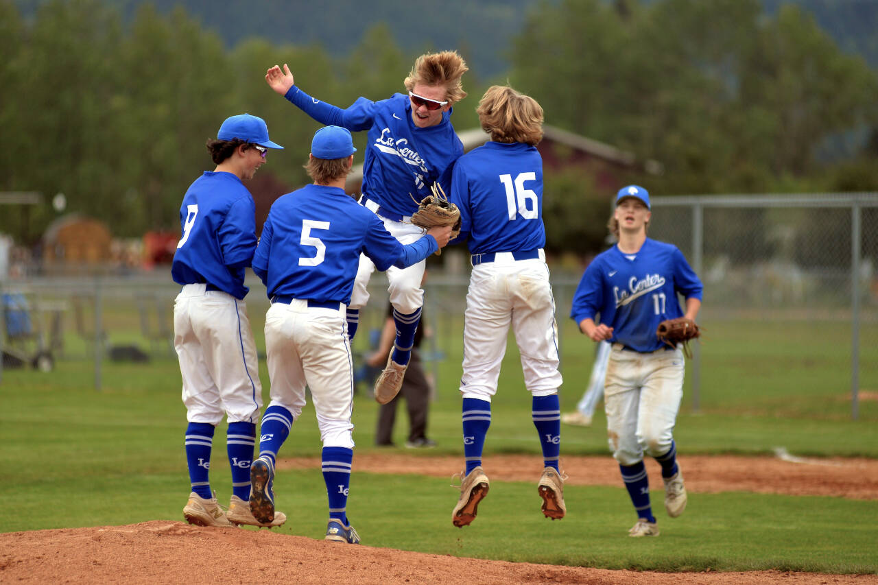 RYAN SPARKS | THE DAILY WORLD The La Center Wildcats celebrate winning the district championship after defeating Elma 3-0 on Friday in Castle Rock.