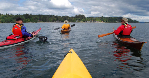 Ken Lambert | Seattle Times | TNS | File Photo 
South Sound Area Kayakers Club members Gerry Hodge, left, Holly Henry and Ted Henry paddle together during a trip from Boston Harbor to Hope Island State Park in Washington.