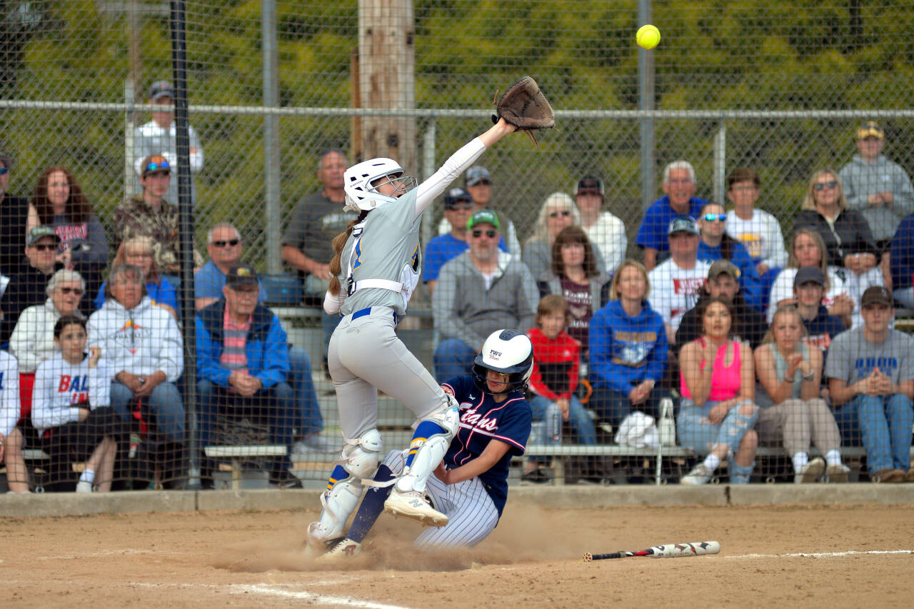 RYAN SPARKS | THE DAILY WORLD Pe Ell-Willapa Valley’s Dani Shannon, right, slides in safe at home while Adna catcher Brooklyn Loose defends during the Titans’ 14-13 loss in the 2B District 4 Tournament championship game on Saturday at Fort Borst Park in Centralia.