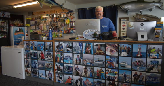 Eric McMurry, owner of Ocean Sportfishing Charters, stands behind a counter that features all local catches from past years in and around Westport. The Westport community is learning to integrate traditional industry into its tourism offerings to create unique and authentic experiences in Grays Harbor. Matthew N. Wells | The Daily World