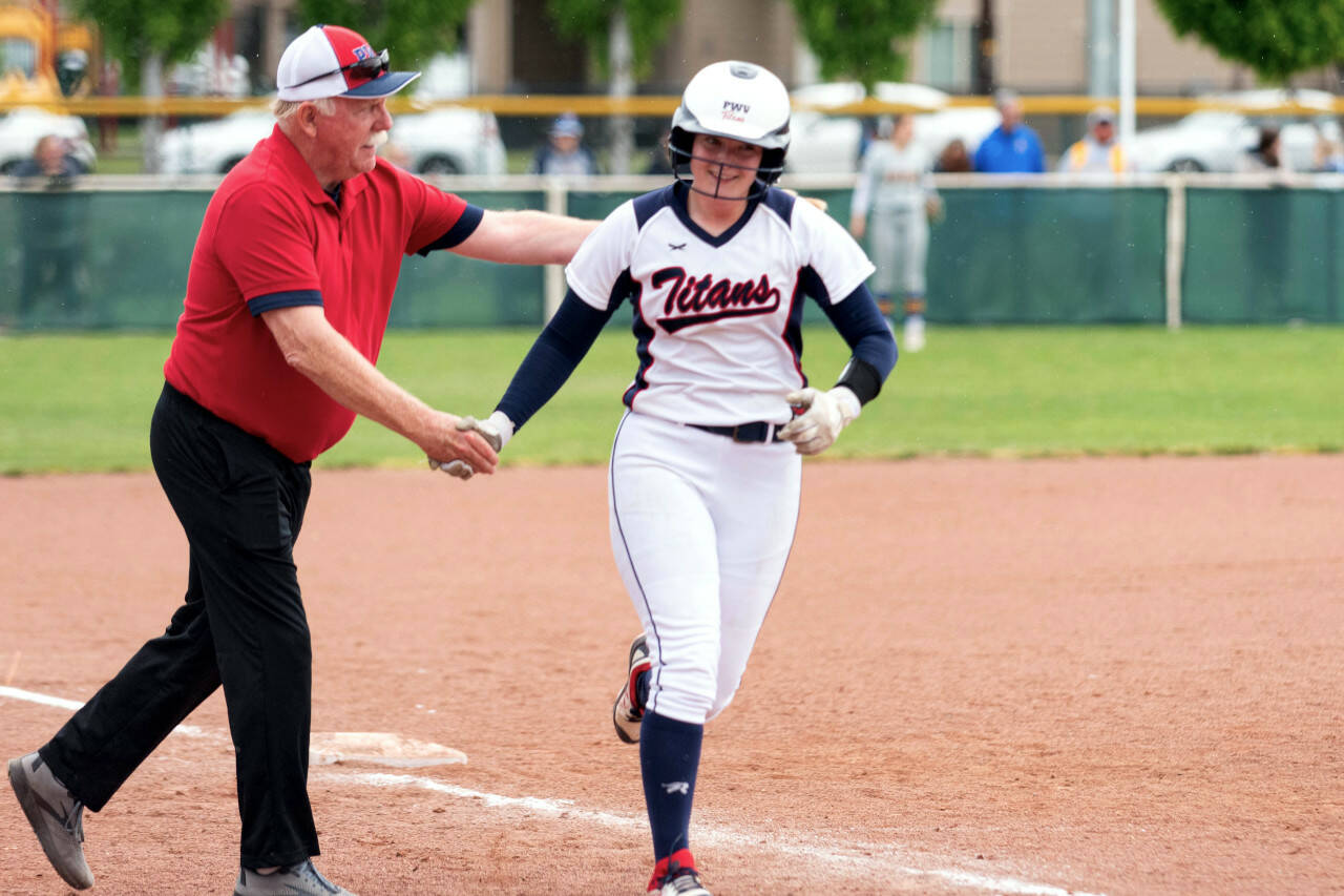 ALEC DIETZ | THE CHRONICLE PWV head coach Ken Olson, left, congratulates Olivia Matlock after the senior hit a home run in an 11-0 win over Adna in the state championship game on Saturday in Yakima.