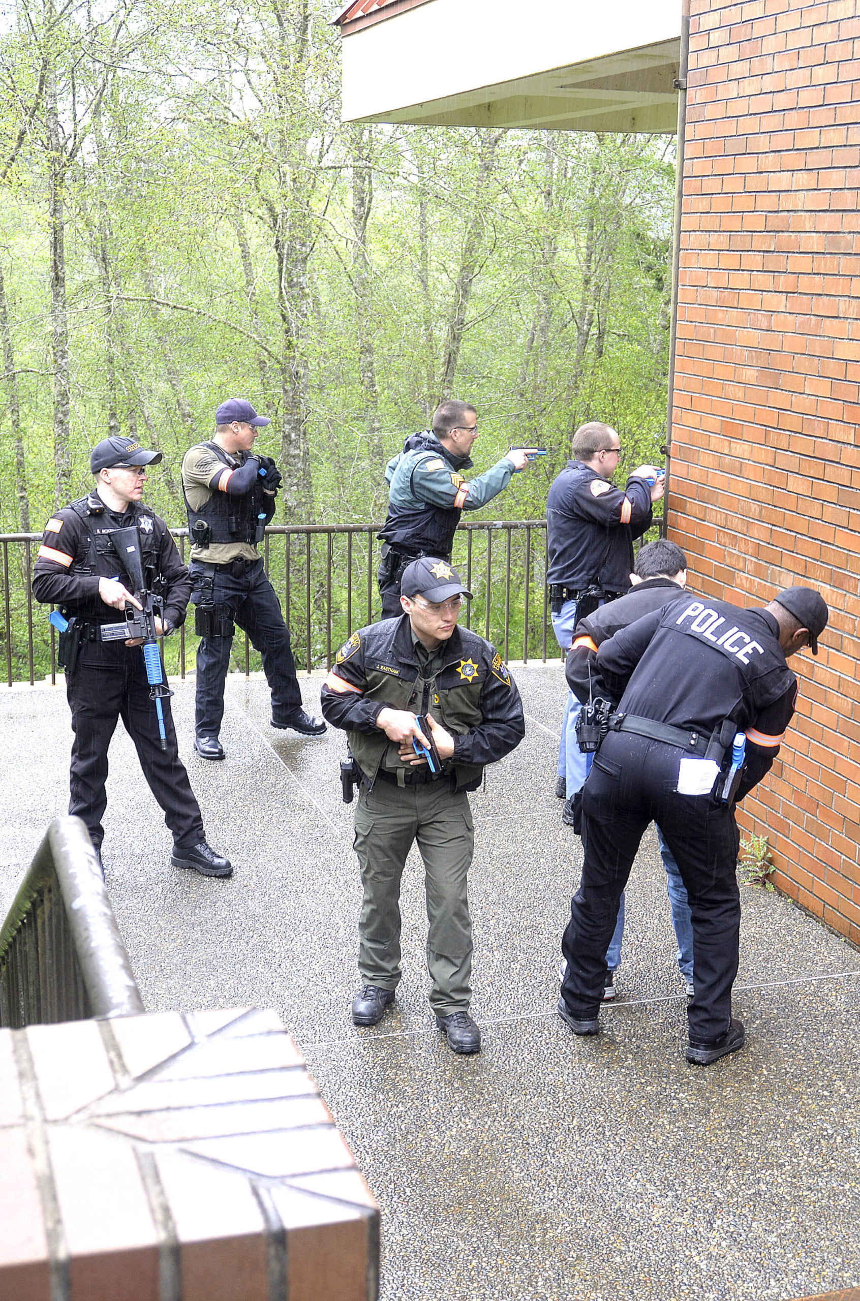 In the active shooter drill, police officers from multiple agencies stage to clear the 800 Building on the Grays Harbor College campus. The college hosted more than 100 first responders for the drill.