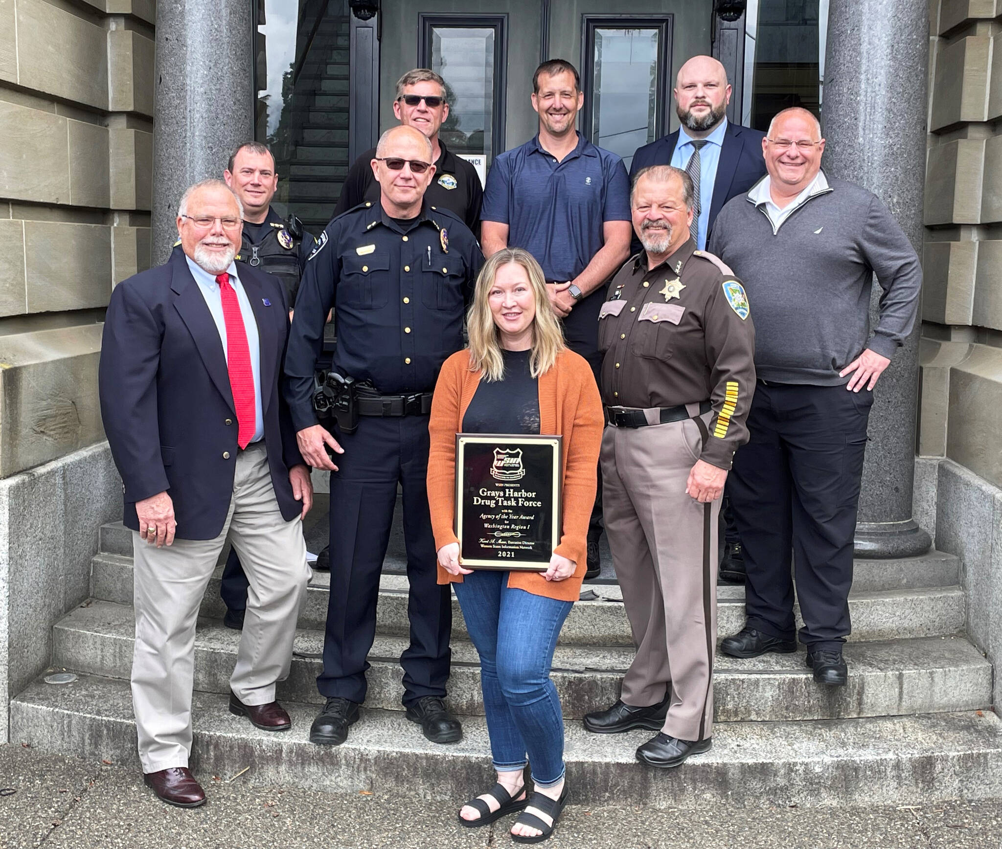 Members of the Grays Harbor County Drug Task Force display the award presented by the Western States Information Network. Front row: Support Specialist Mendi Stump. From left, second row: John Martin (WSIN), Hoquiam PD Interim Chief Joe Strong and GH Sherriff Rick Scott; third row: Aberdeen Interim Chief Dale Green and GHSO Chief of Investigators Darrin Wallace; Back row: APD Deputy Chief Jay Staten, GHSO Chief Criminal Deputy Kevin Schrader and GH Senior Deputy Prosecutor Scott Gripp. Submitted photo
