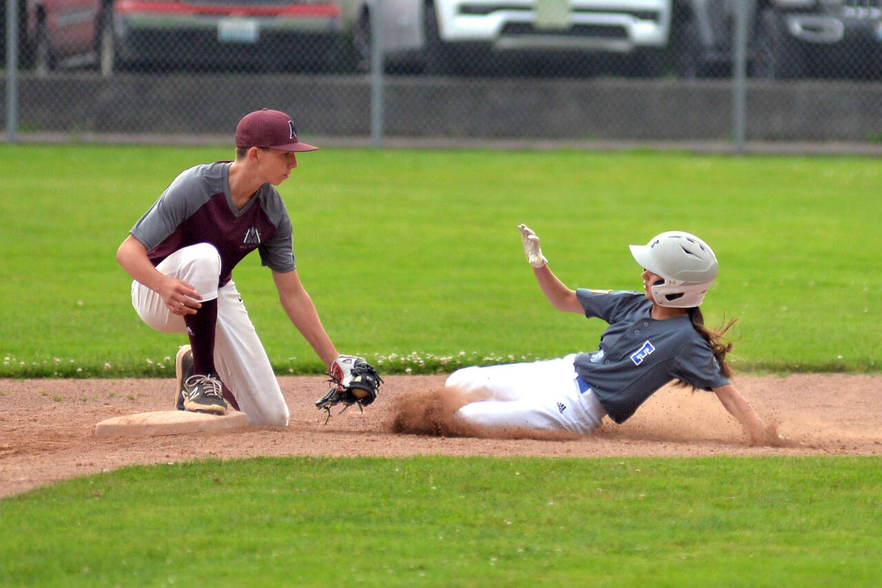 RYAN SPARKS | THE DAILY WORLD Montesano shortstop Tyson Perry, left, tags out Elma’s Eliza Courts during Montesano’s 17-7 victory on Wednesday at Vessey Field in Montesano. The victory gave the Montesano Junior Little League All-Stars the district title.