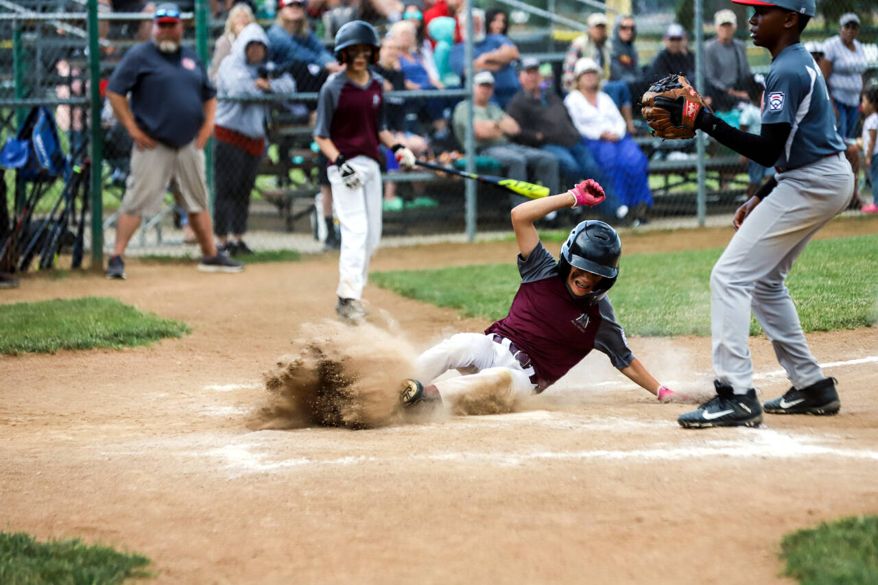PHOTO BY LARRY BALE
Montesano's Cruz Vargas slides in to home in Monte Little League's 8-3 victory over Capitol in the deciding game of the Majors District 3 Tournament on Saturday in Chehalis.