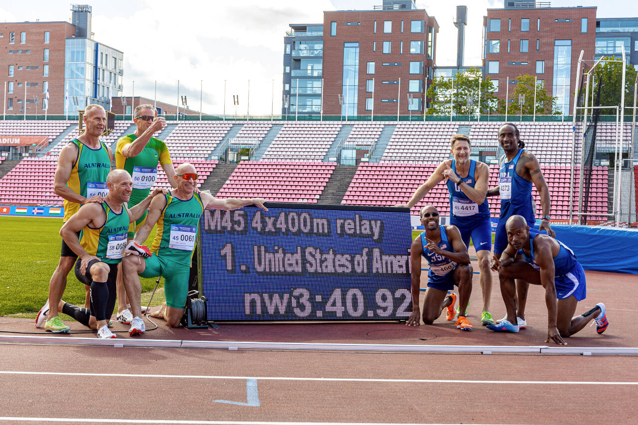 SUBMITTED PHOTO Montesano’s Josh Huff, third from right, and the rest of the Team USA M45 4x400 relay team pose for a photo with team Australia after the two teams tied for first on July 10, 2022, at the World Masters Athletics Championships in Tampere, Finland.