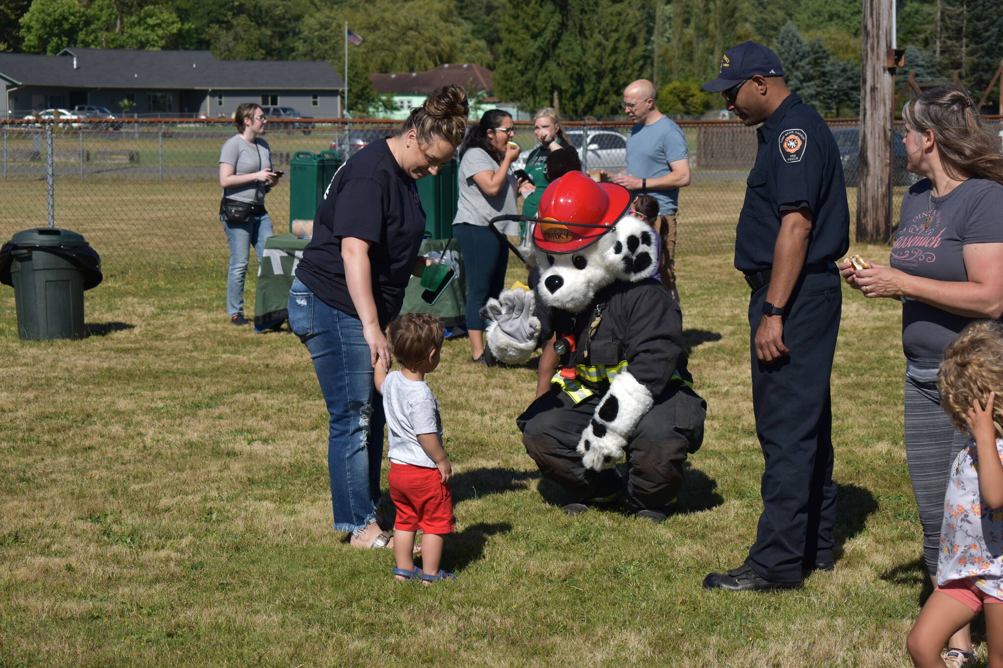 Kids attending the National Night Out festivities in Elma were greeted by Sparky, the East Grays Harbor Fire and Rescue Mascot. Sparky showed kids around the parked firetrucks and let them hold hoses and gear. (Allen Leister | The Daily World)