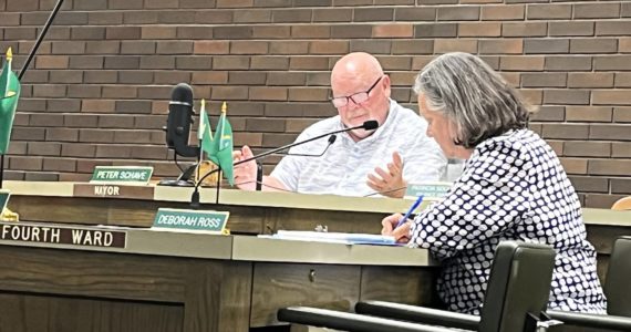 Mayor Pete Schave talks during the Aberdeen City Council meeting on Wednesday night, Aug. 11, 2022, while Ward 4 Position 8 council member Deborah Ross focuses in. (Matthew N. Wells | The Daily World)