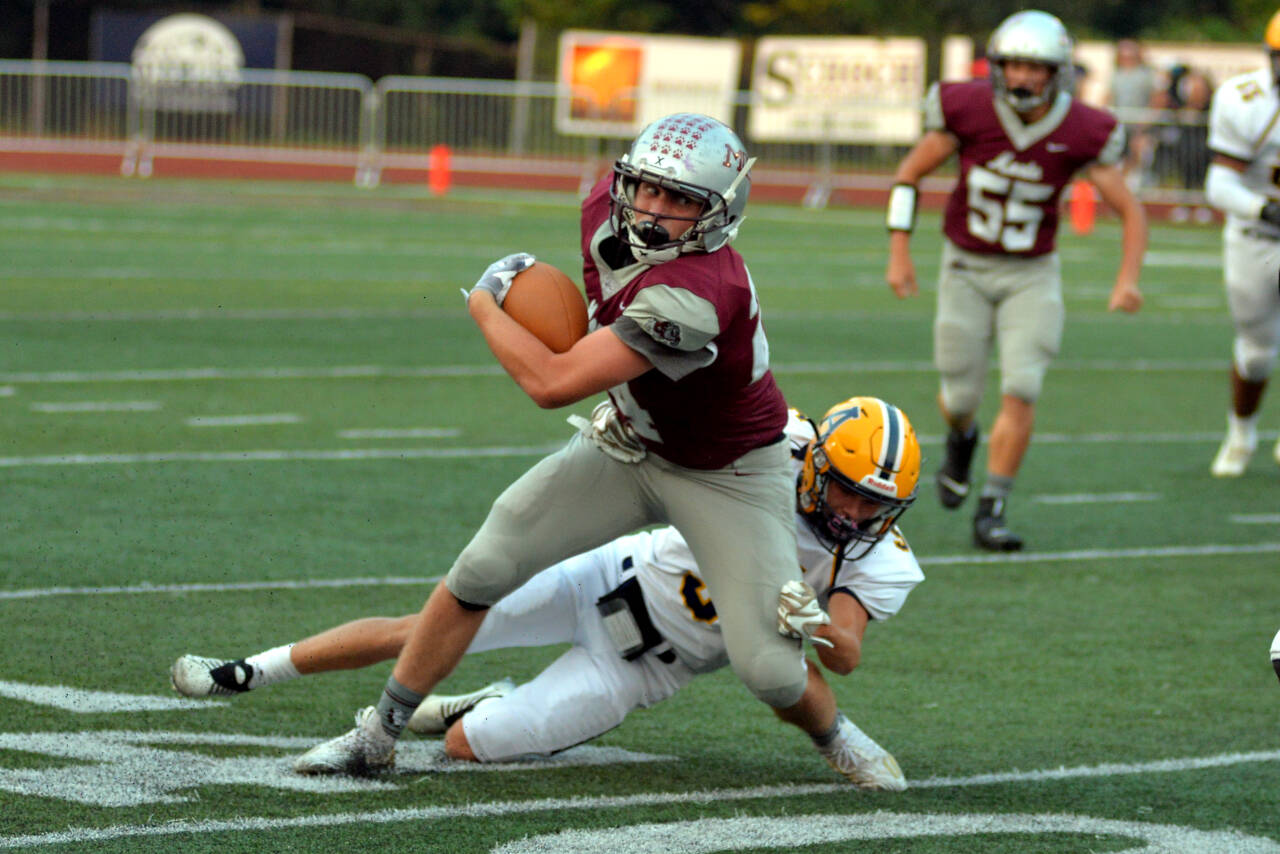 RYAN SPARKS | THE DAILY WORLD Montesano receiver Tyler Johansen, foreground, attempts to escape the tackle of Aberdeen defender Kyle Miller (5) during the Bulldogs’ 29-0 win on Friday in Montesano.