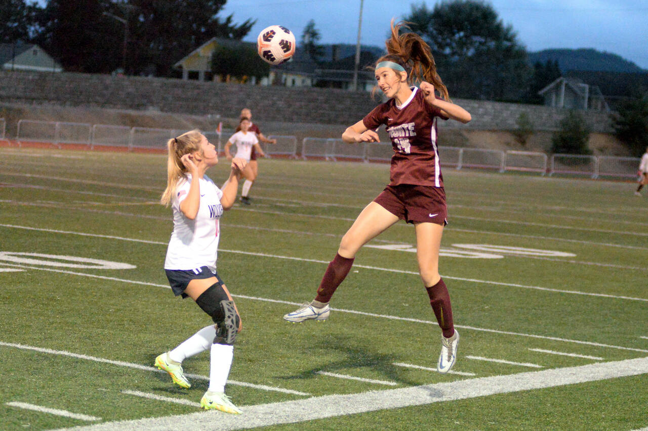 RYAN SPARKS | THE DAILY WORLD Montesano defender Dekotah Parks (34) heads the ball away from Black Hills forward Mia Thompson during the Bulldogs’ 6-1 win on Thursday, Sept. 22, 2022 at Jack Rottle Field in Montesano.