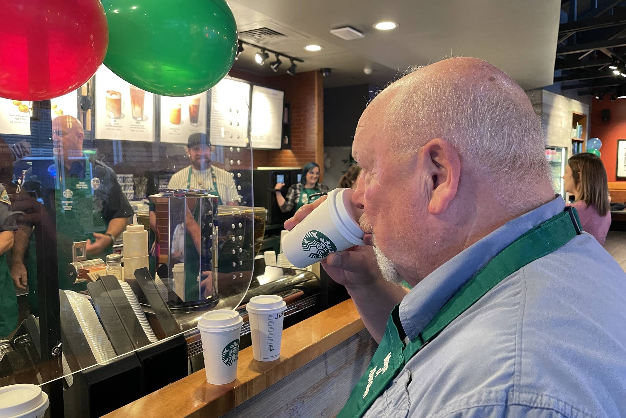 Michael S. Lockett / The Daily World 
Aberdeen Mayor Pete Schave judges a latte-making competition at Badges & Brews, hosted at Starbucks.