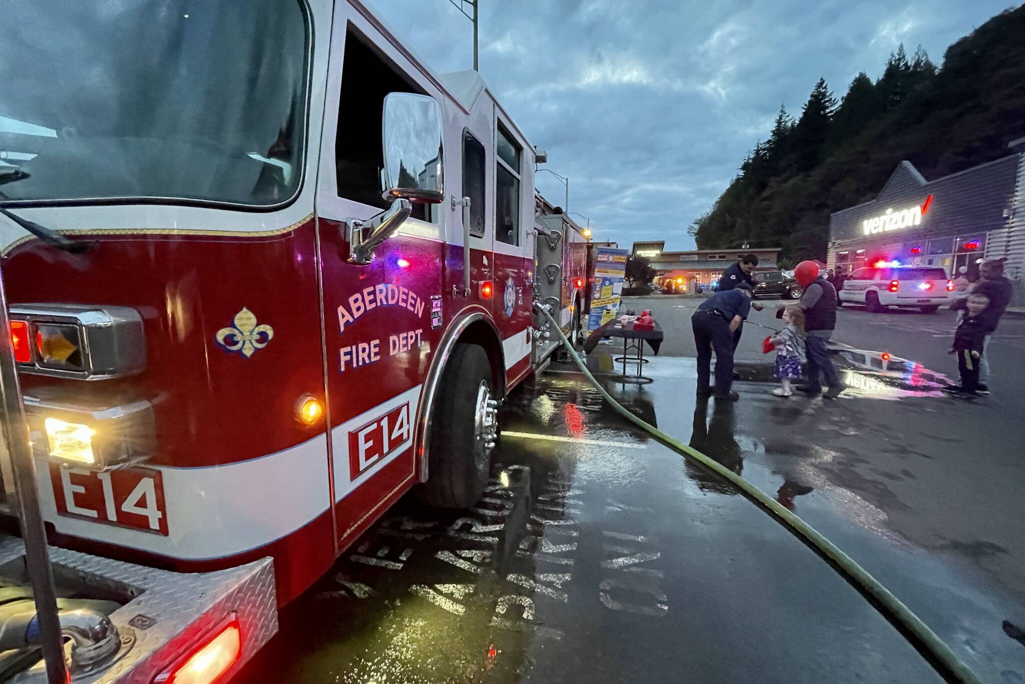 The Aberdeen Fire Department demonstrated spraying down a target at Badges & Brews, hosted at Starbucks on Sept. 22, 2022. (Michael S. Lockett / The Daily World)