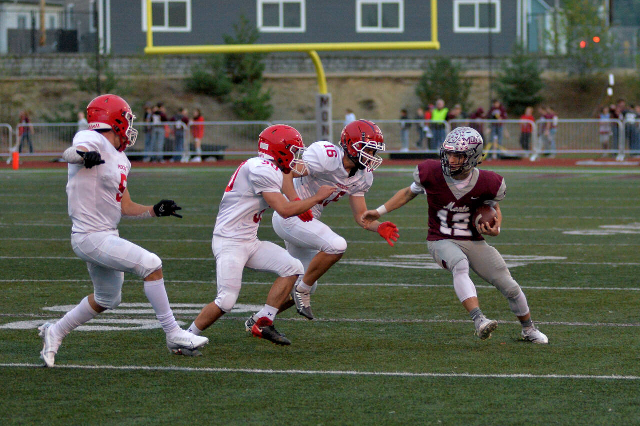 DAILY WORLD FILE PHOTO Montesano’s Cole Ekerson (12) is chased by Castle Rock defenders in a win on Friday, Sept. 23, 2022 in Montesano. The Bulldogs will have a tough road test when they take on the Shelton Highclimbers on Friday.
